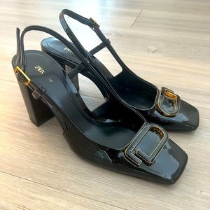 Chic block heeled shoes with black and gold design.